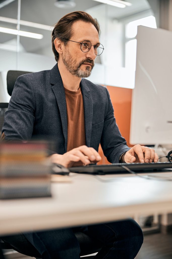 Male office worker looking at computer screen